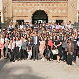 A large group of law students posing in front of a law building with arched doorways