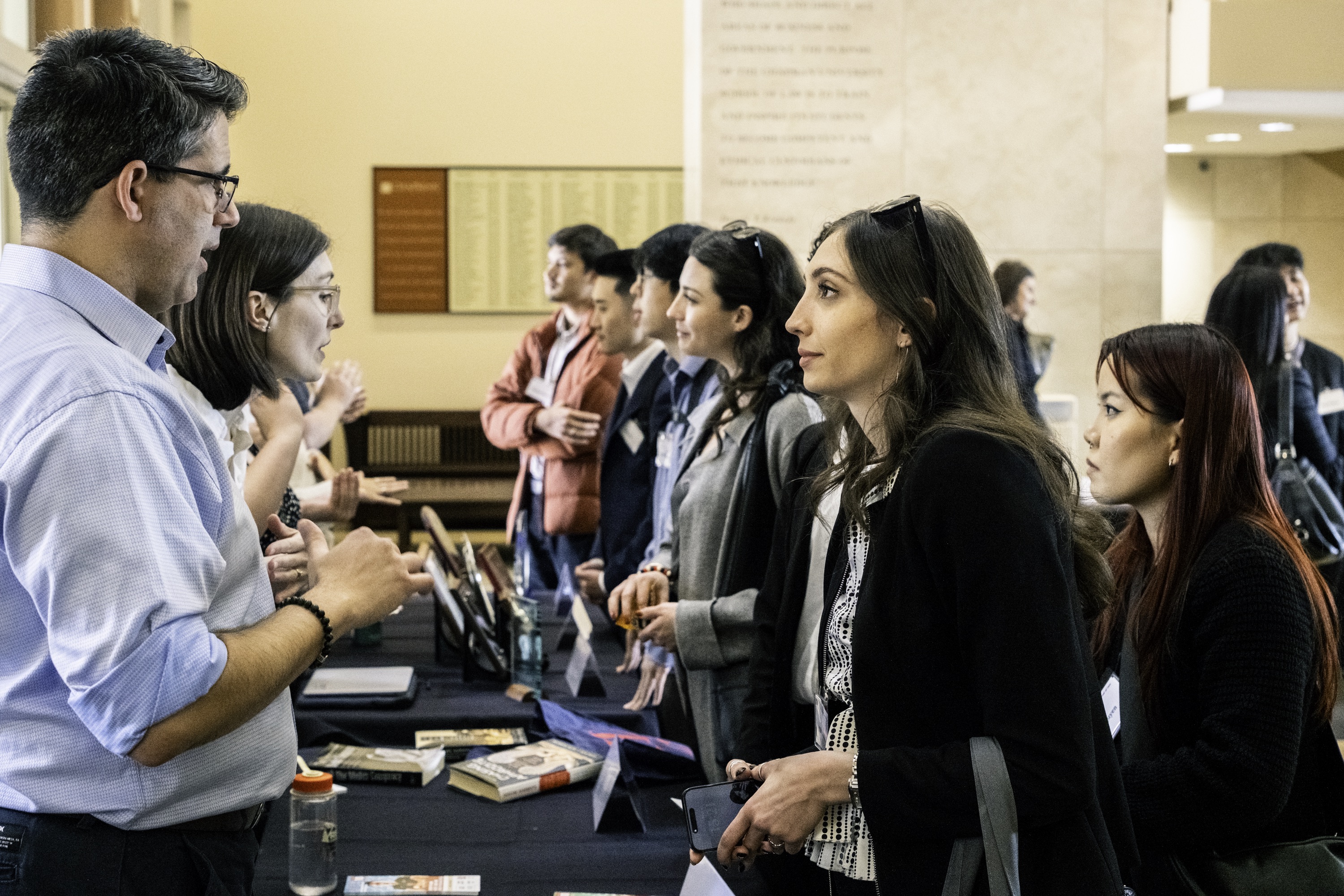 Photograph of a Chapman Law students and alumni discussing competition teams during Scholars Weekend.